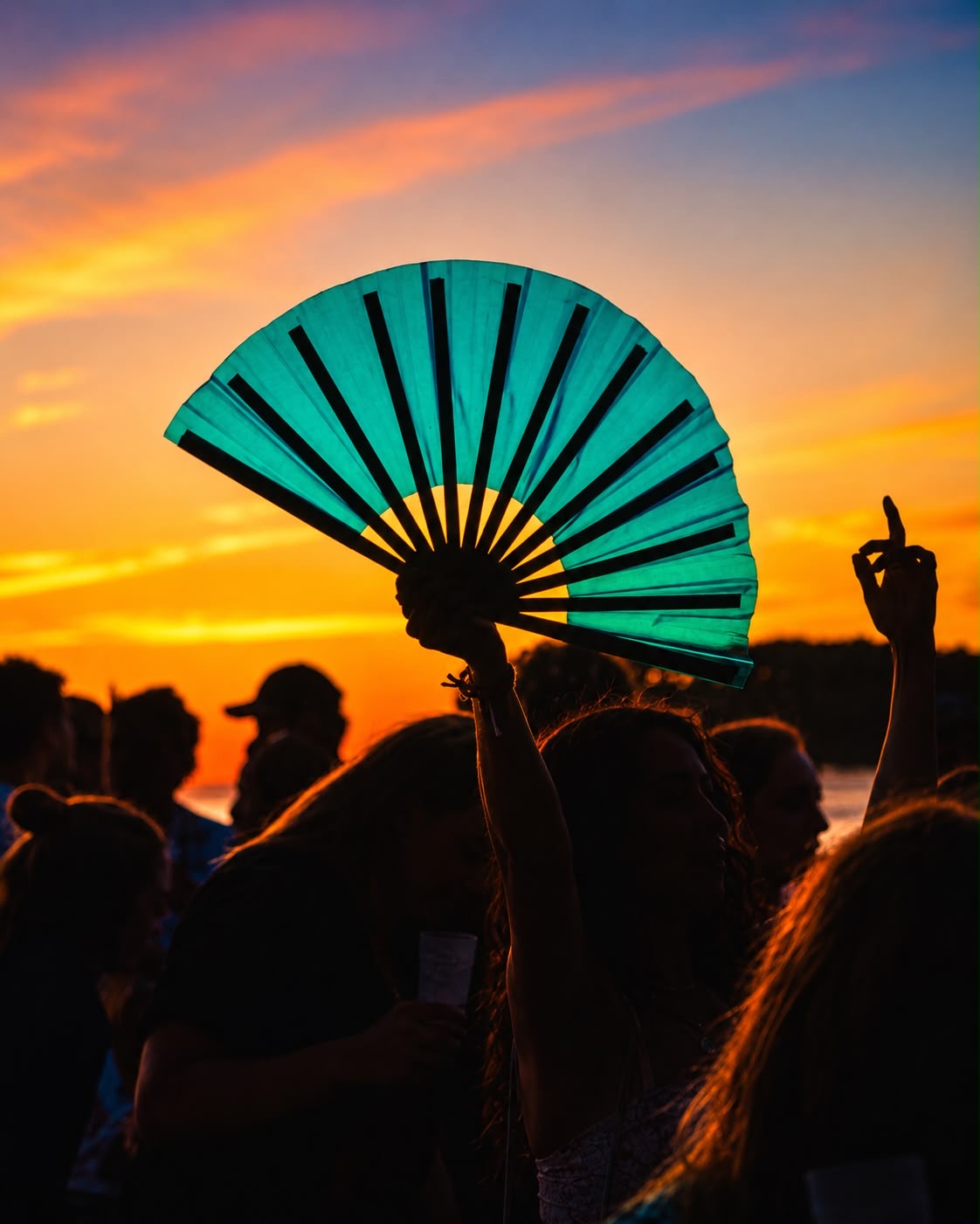 Sunset party silhouettes with a clack fan
